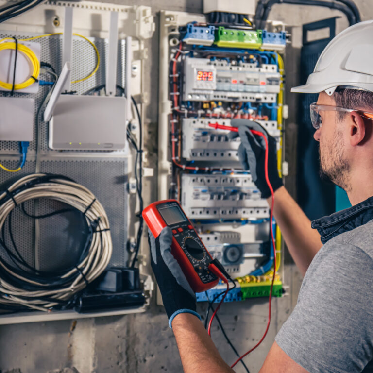 LLE_man-electrical-technician-working-switchboard-with-fuses